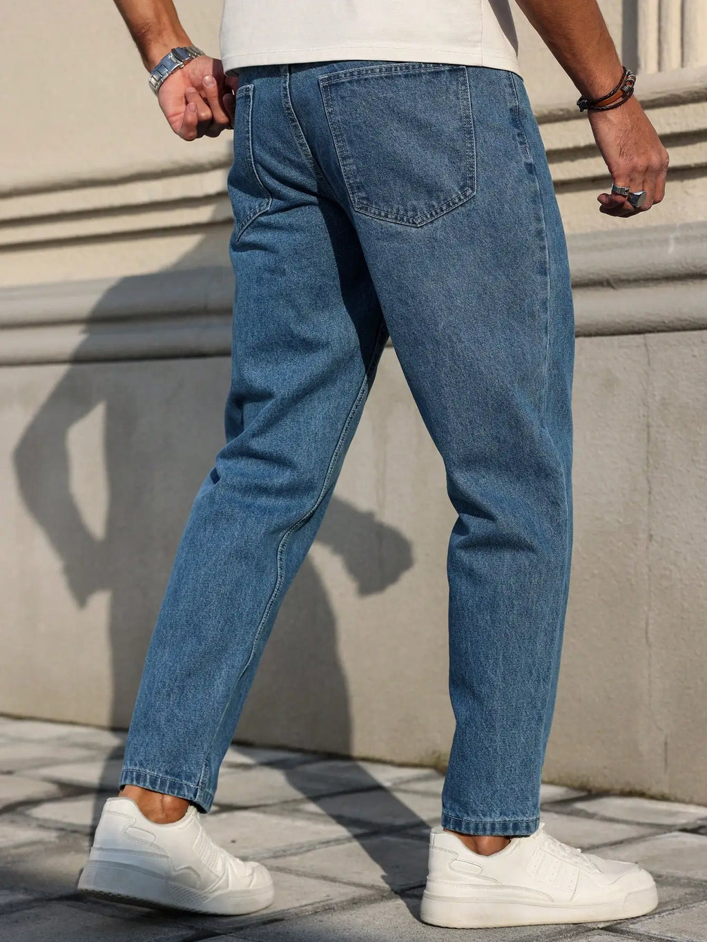 Men's jeans classic blue denim fabric with a loose fit,
